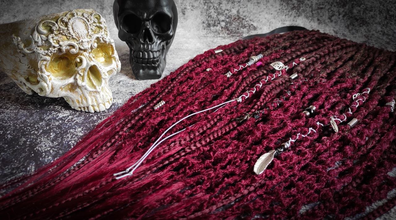 brown burgundy ombre synthetic dreads with black and white skulls near them