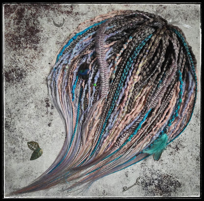 Pastel synthetic dreads with turquoise and brown-to-pink ombre extensions, including purple accents.
