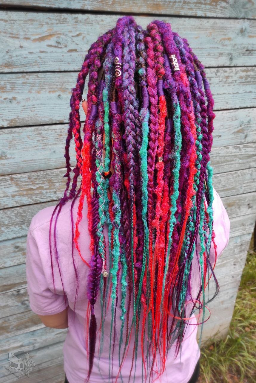 Synthetic dreads with braids featuring a striking ombre effect transitioning from purple to green and orange